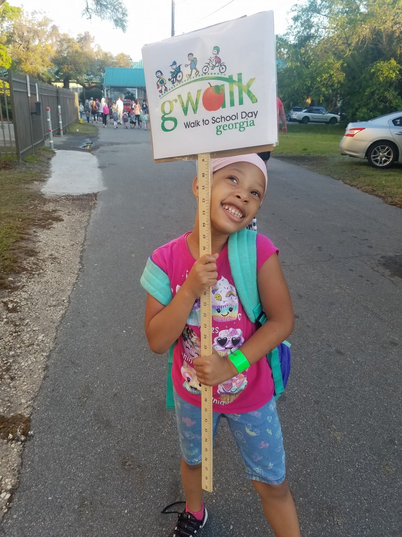 Young girl holding a sign that says Walk to School Day Georgia